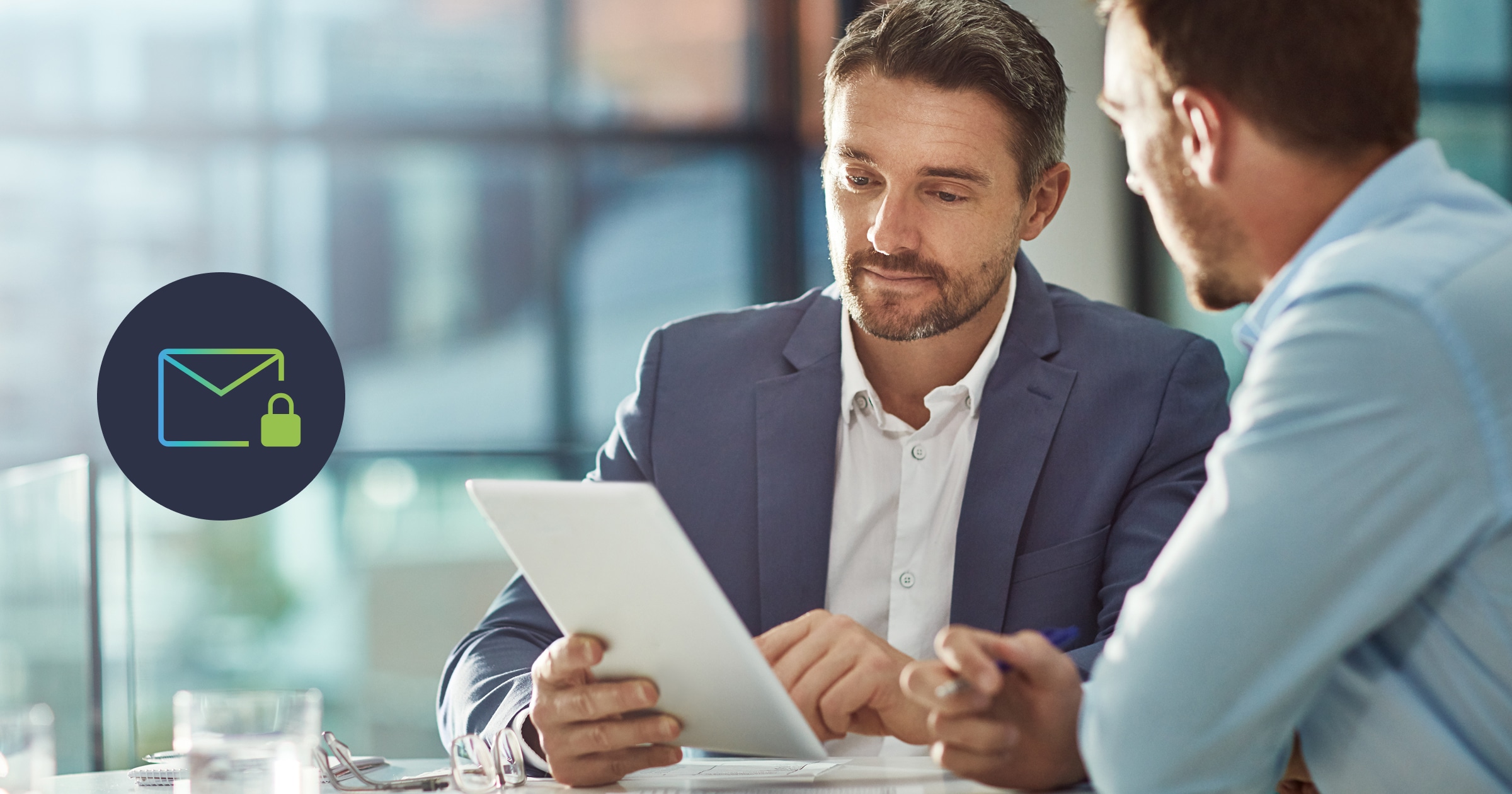 Two financial advisors reading a tablet at desk with email security breach warning icon. Arakÿta cybersecurity for financial services